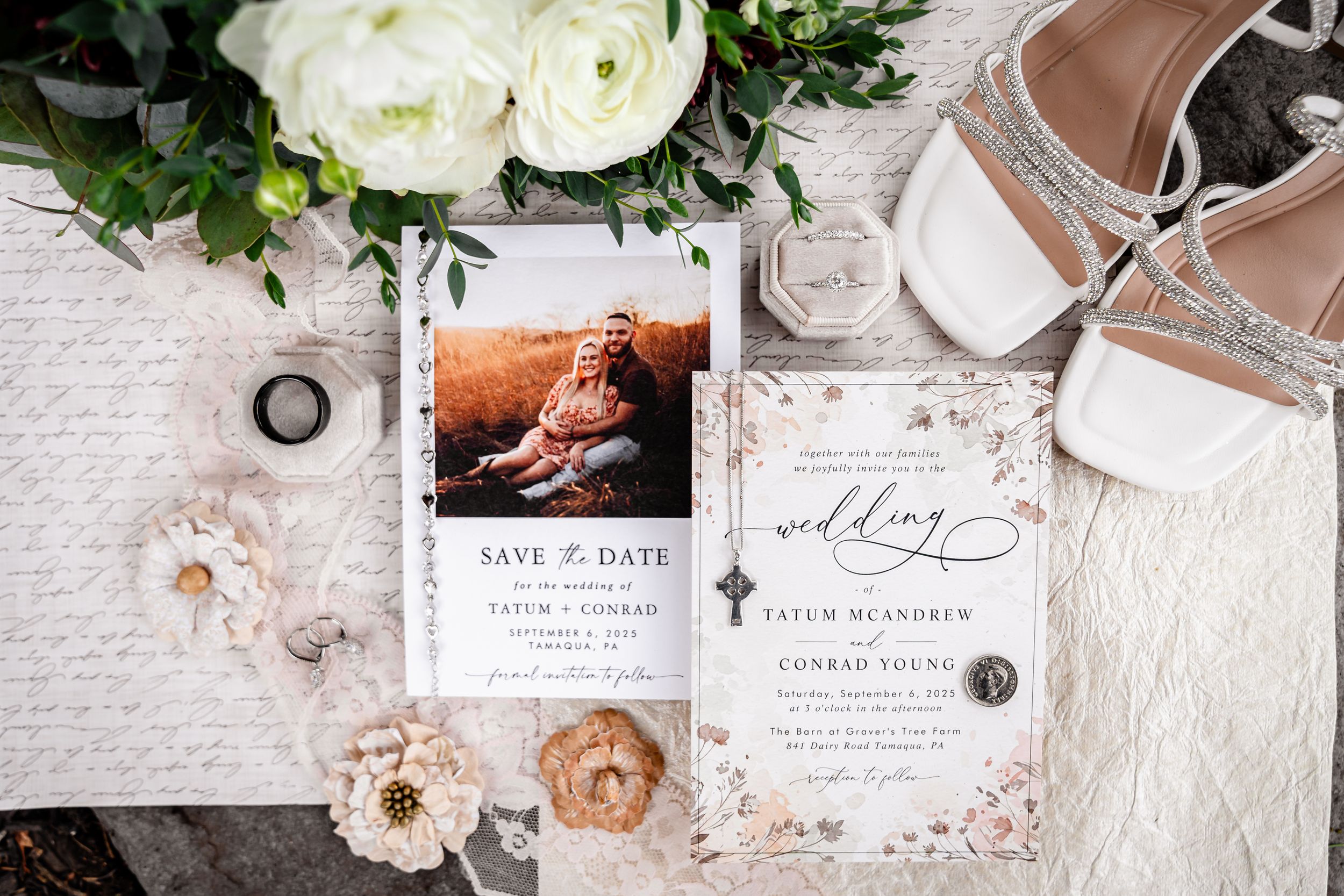 Wedding details including invitations, rings, and floral arrangements in white and blush tones.