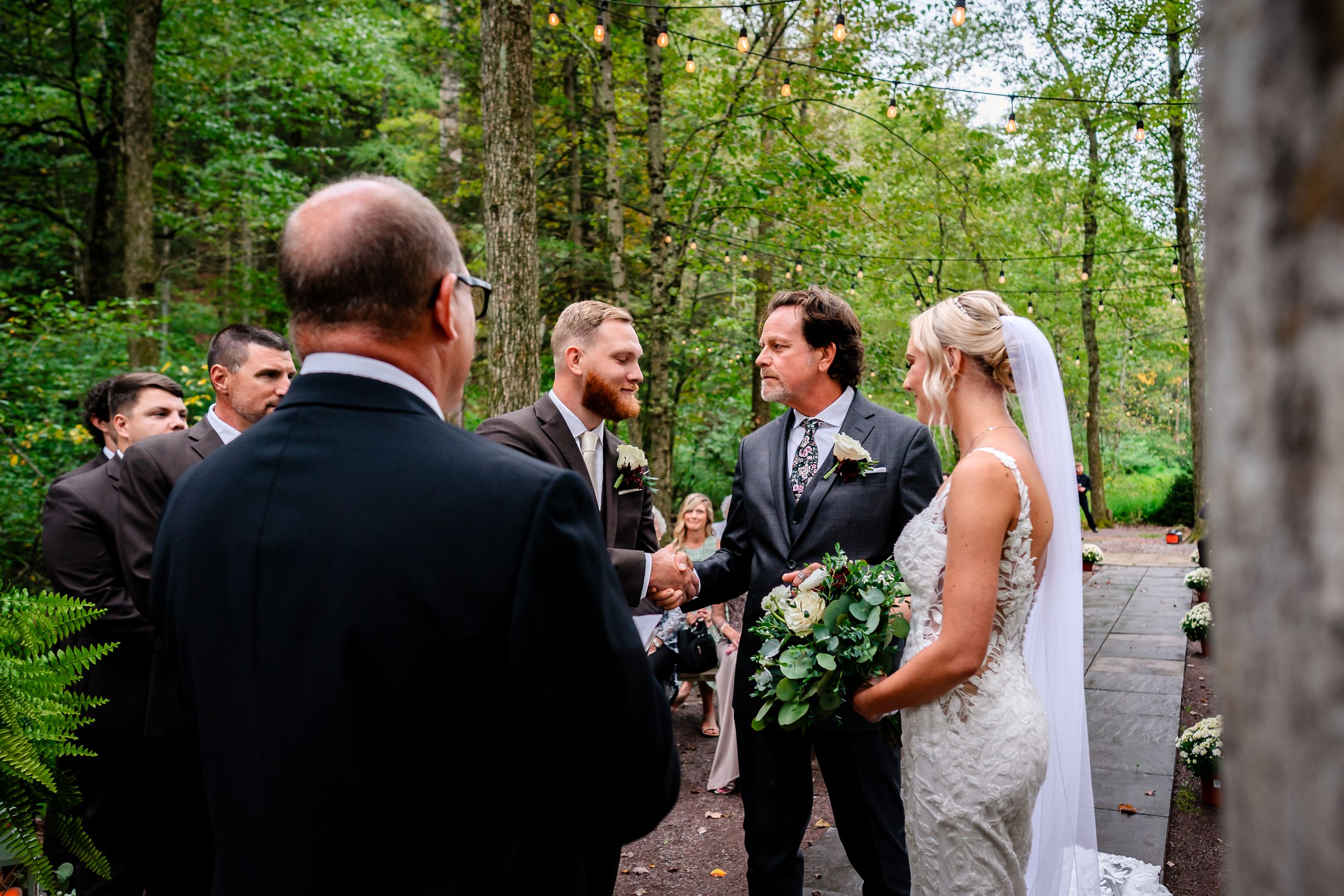 Wedding celebration candid moments captured in an outdoor forest setting.