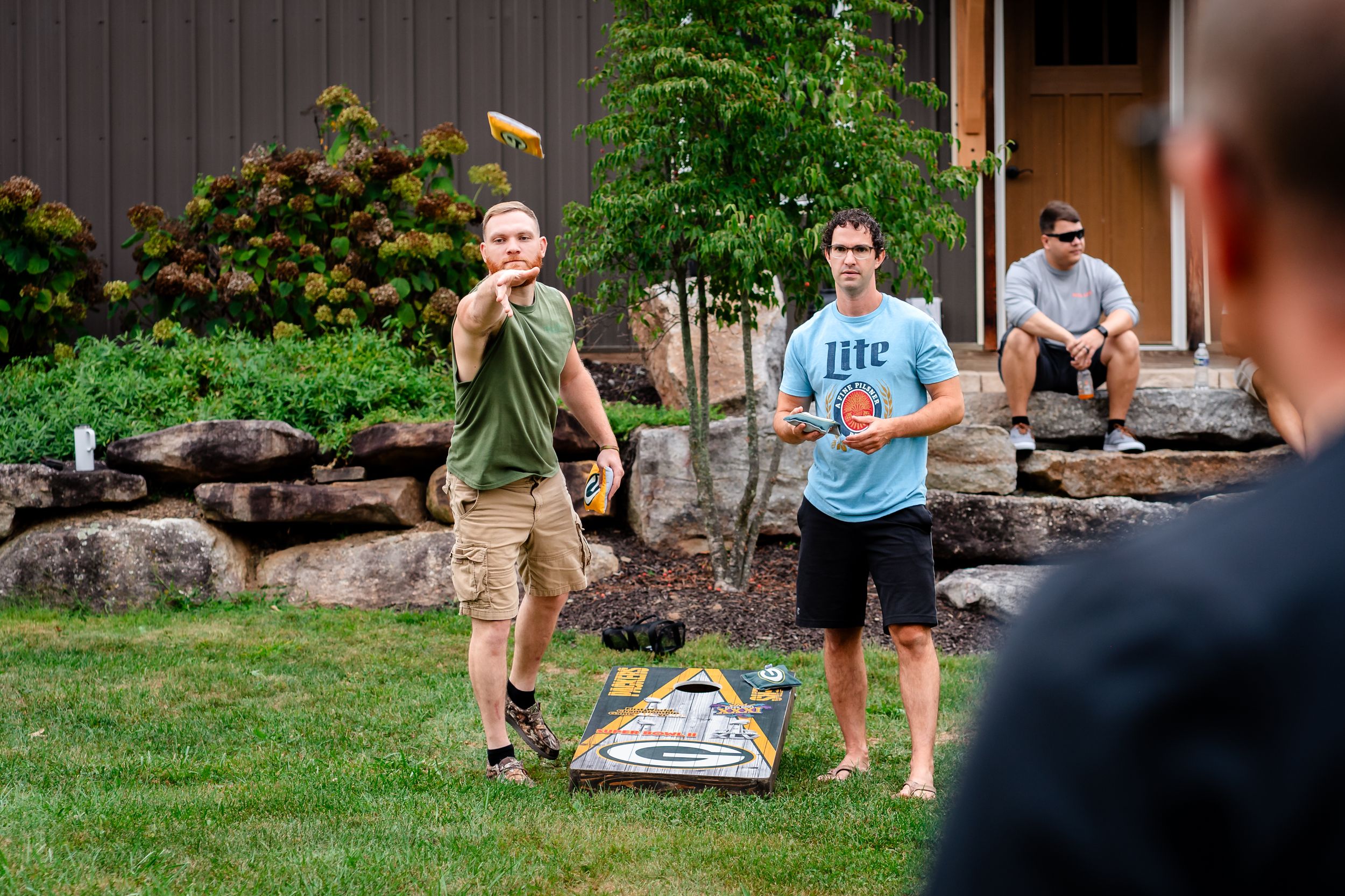 Outdoor wedding reception setup with lawn games and casual gathering spaces.
