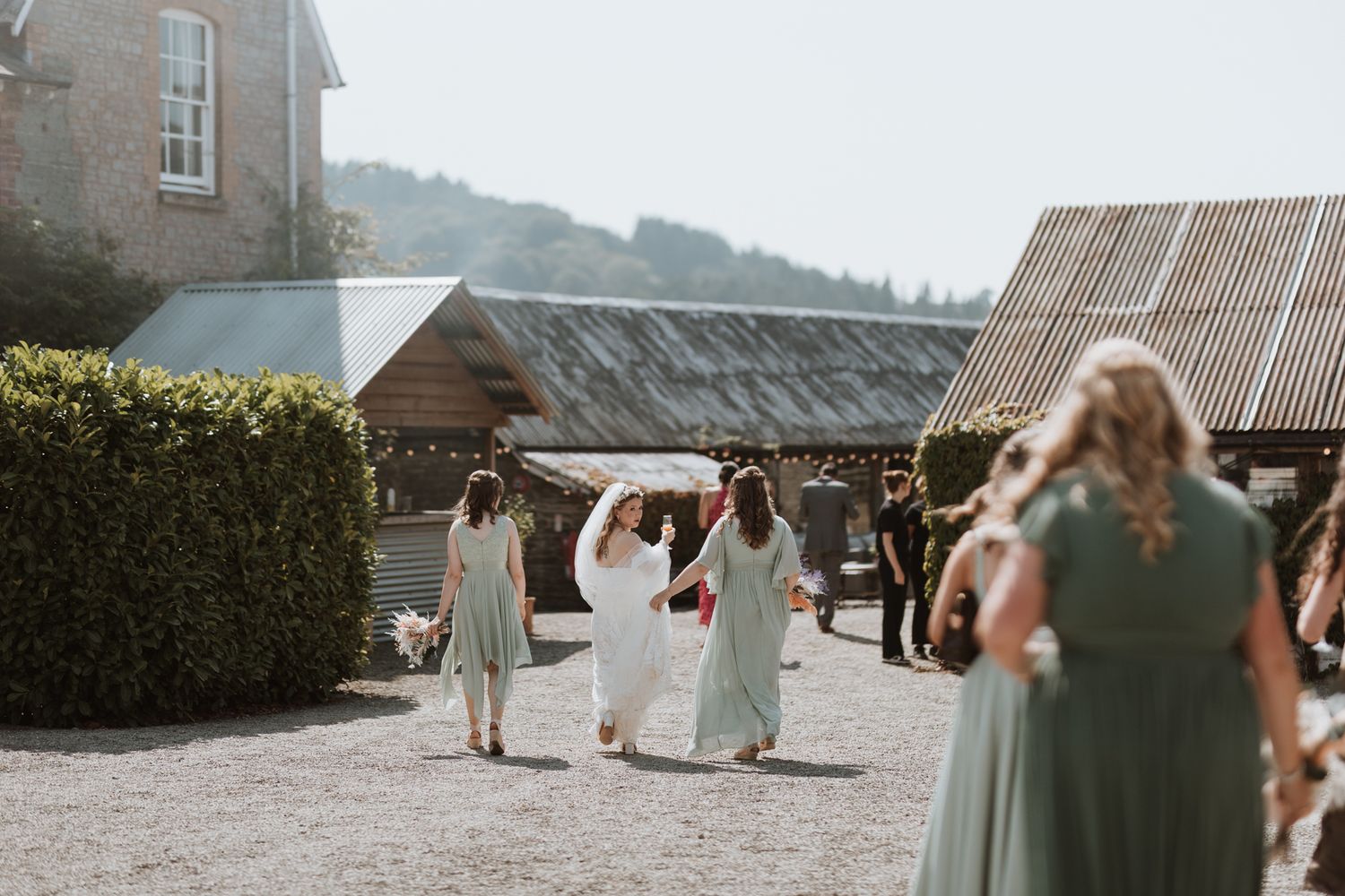 A series of wedding photos showing outdoor venue details and bridal party in green dresses against a rustic stone backdrop at Wildelodge