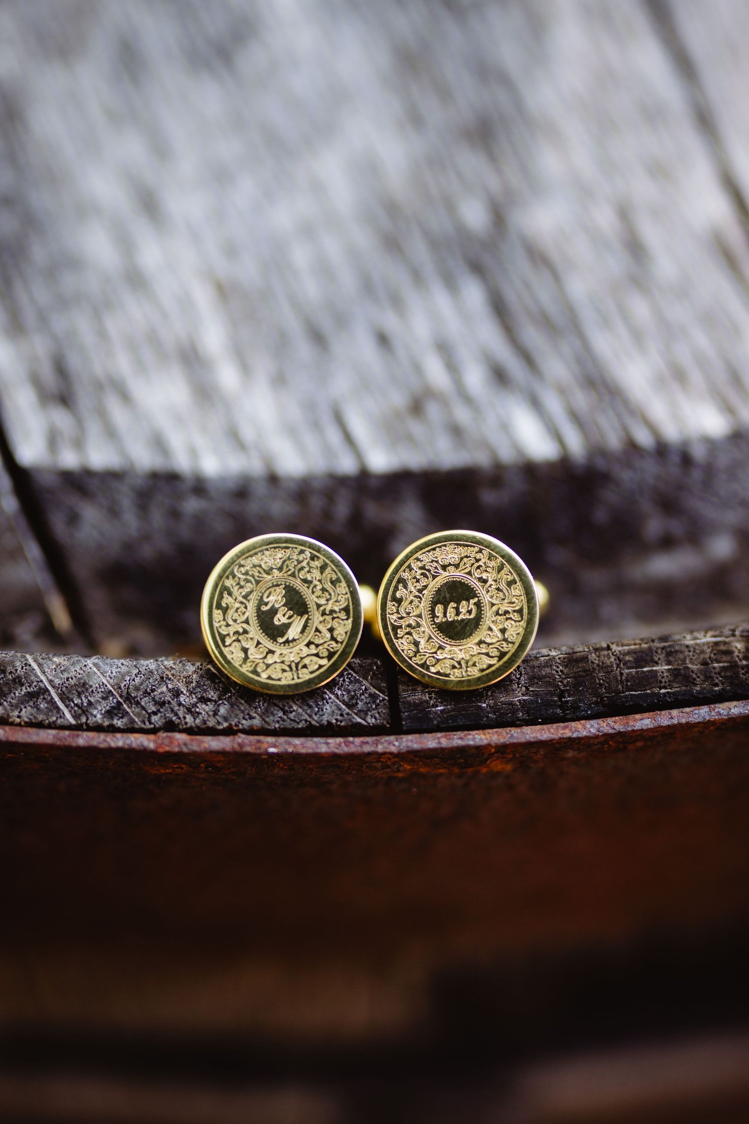 Golden glittery wedding cufflinks displayed on a dark textured surface in sequence.