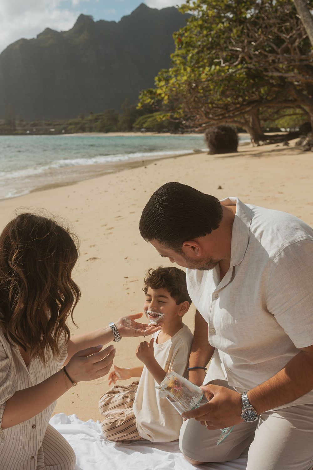 Family enjoying quality time while playing together on a beautiful tropical beach at sunset.