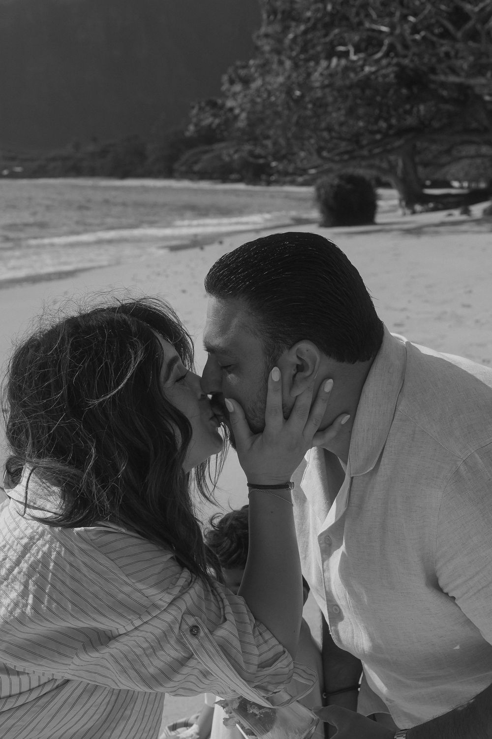 A black and white photo sequence shows a romantic kissing moment between two people outdoors.