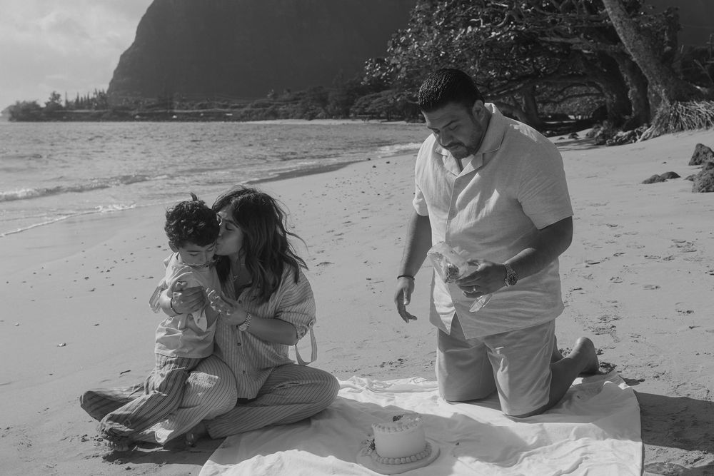 A series of black and white photos showing people in intimate moments on a sandy beach, embracing and enjoying the outdoors.