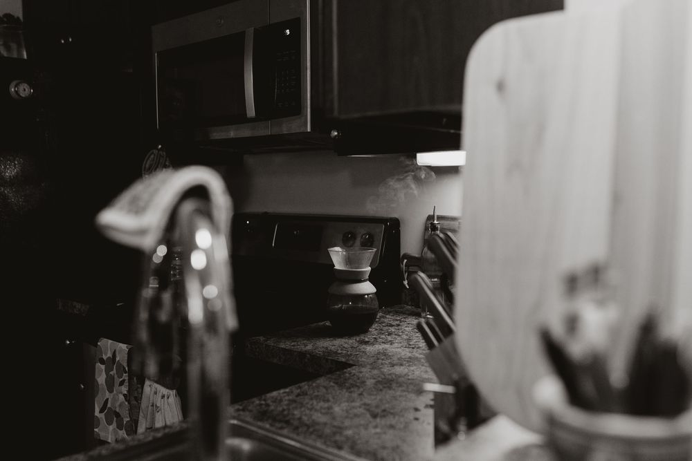 A black and white photo shows a French press releasing steam. Whitney Popp Arizona photographer