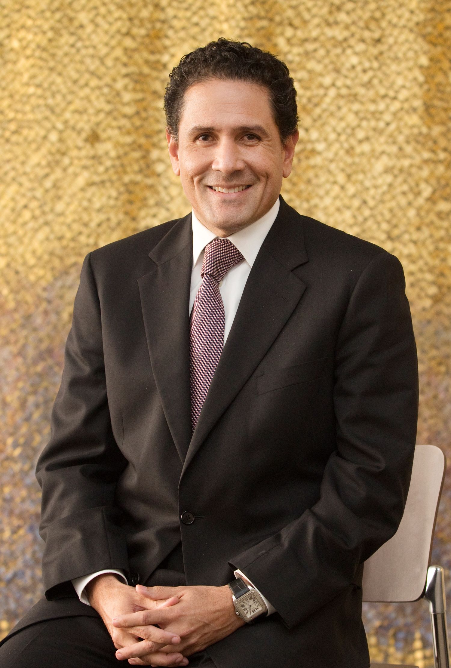 A banker poses for a photo in his office.
