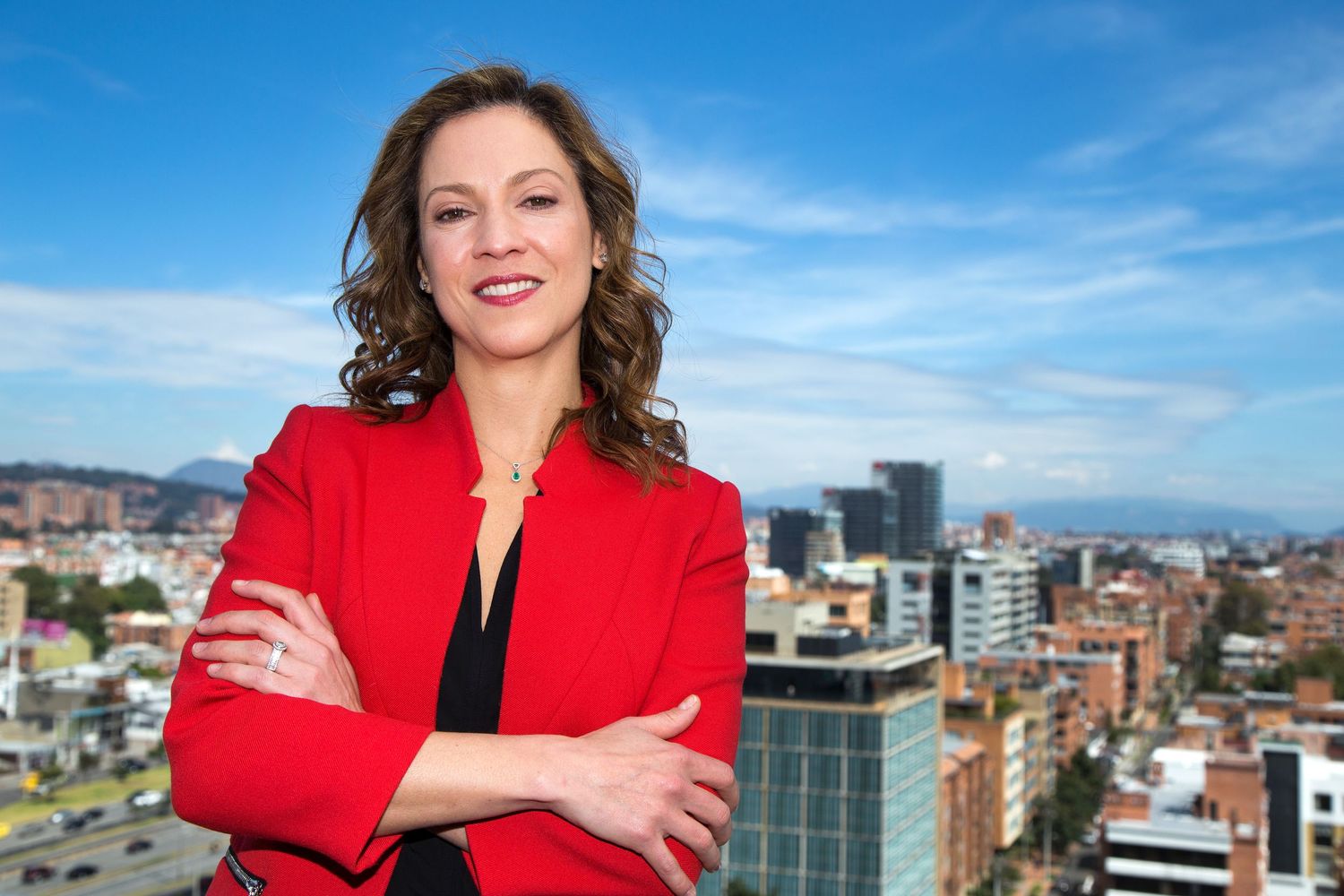 A businesswoman poses for a photo in her office.