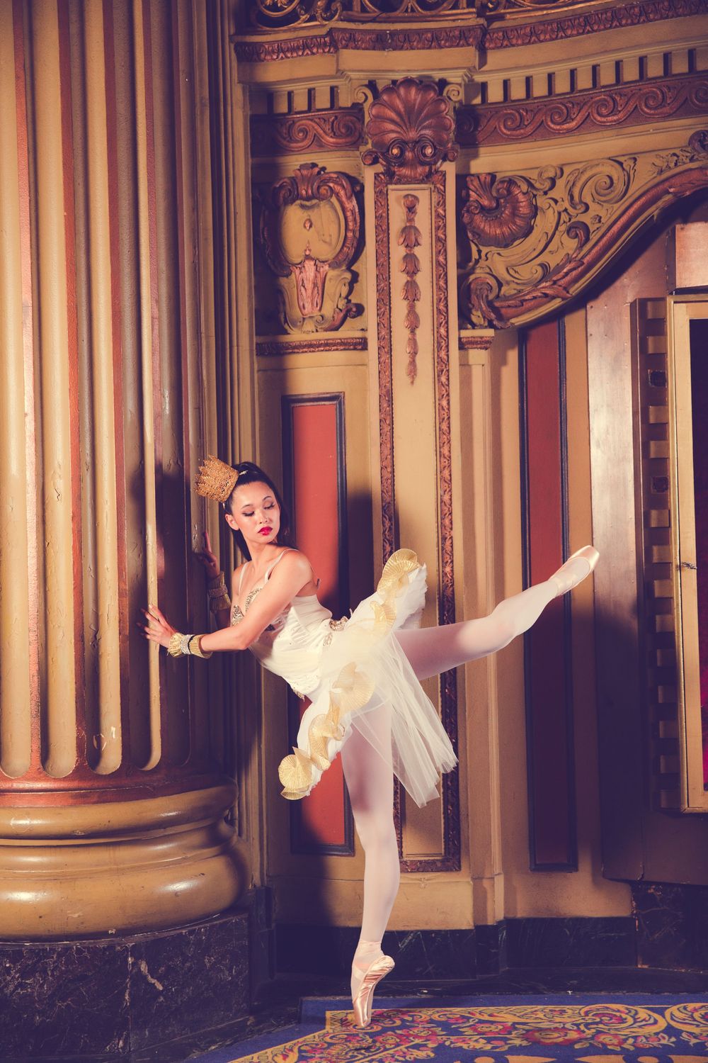 Ethereal dance movements in white costume against classical architectural columns.