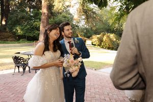 Couple shares intimate moments during outdoor wedding photoshoot in park setting with beautiful natural lighting.
