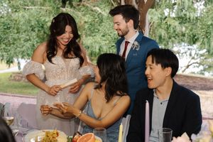 Wedding celebration candids show joyful interactions between guests at outdoor garden reception.