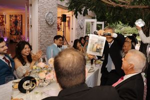 A group of people mingling and socializing at an elegant indoor event or gathering.