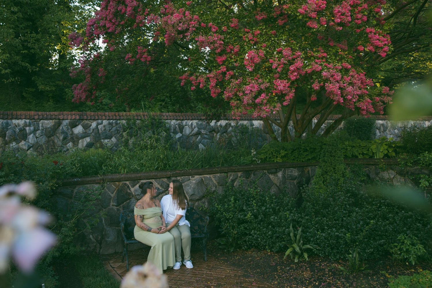 LGBTQ couple holding hands after romantic proposal at blue ridge mountain overlook near Asheville, North Carolina
