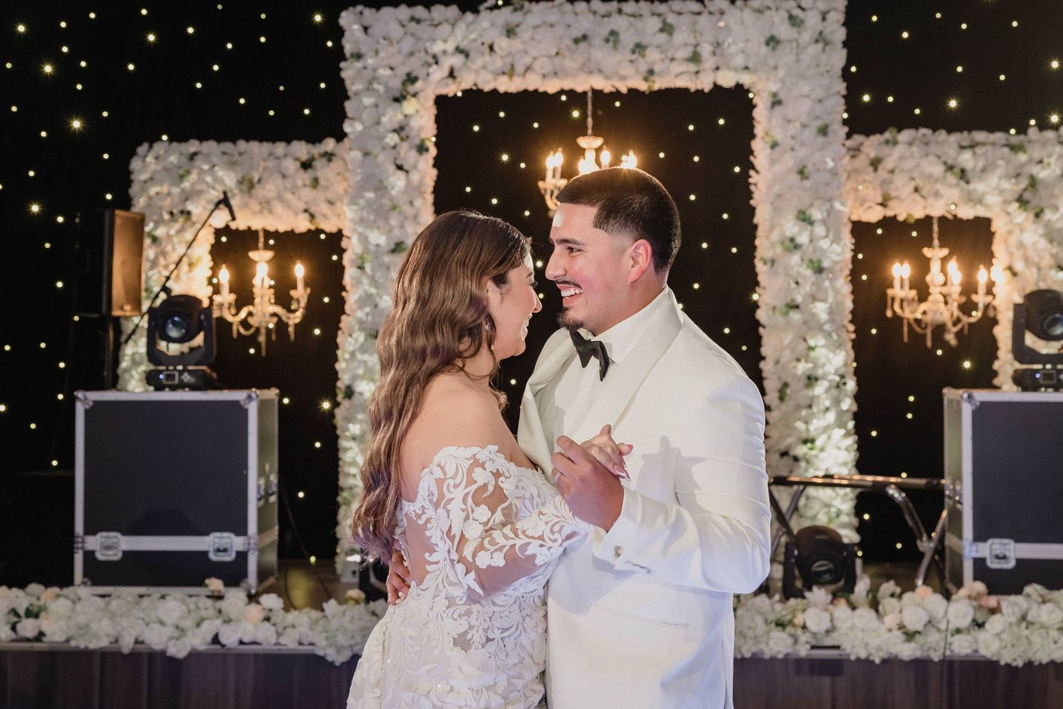 Couple share first dance dance together on an illuminated ballroom floor during a wedding reception celebration for Sacramento wedding