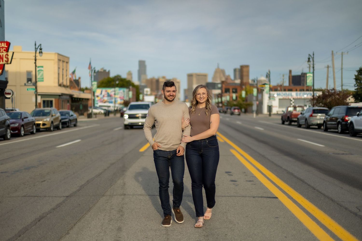 engagement shoot with Detroit skyline behind the couple