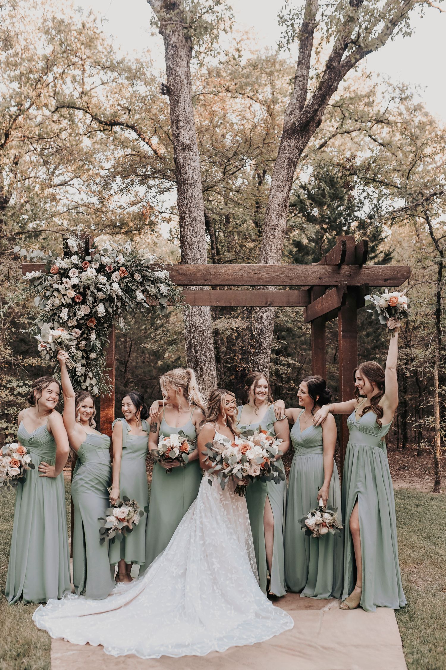 Bridesmaids in dusty blue dresses posing with bride – April Pinto Photography