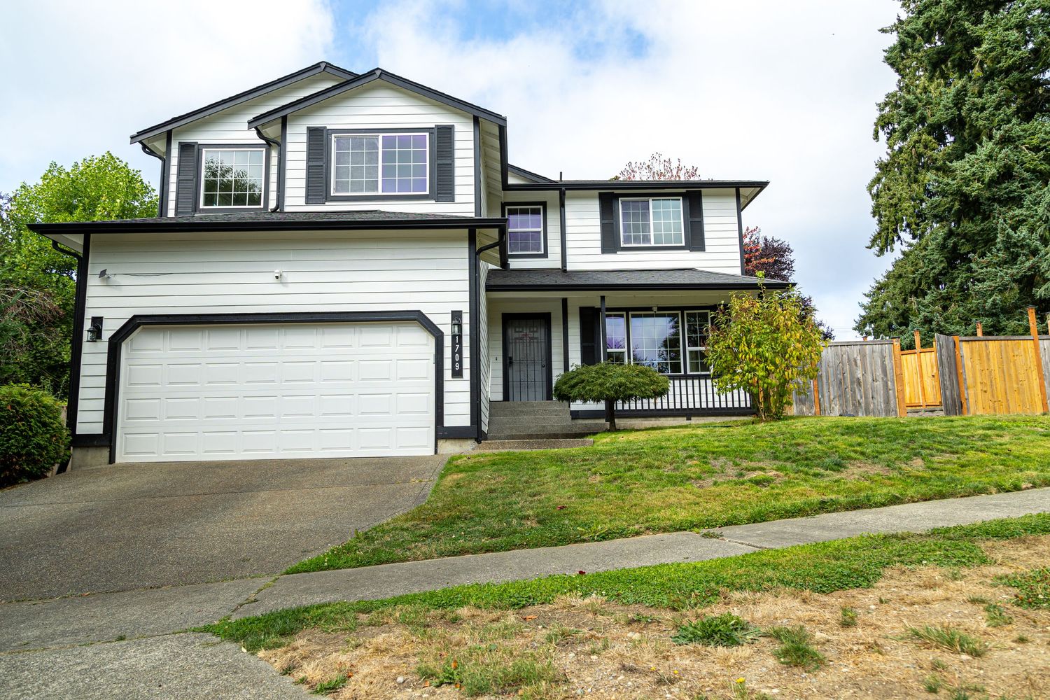 A connected series of exterior views of a residential house showing different angles and perspectives with trees in background.
