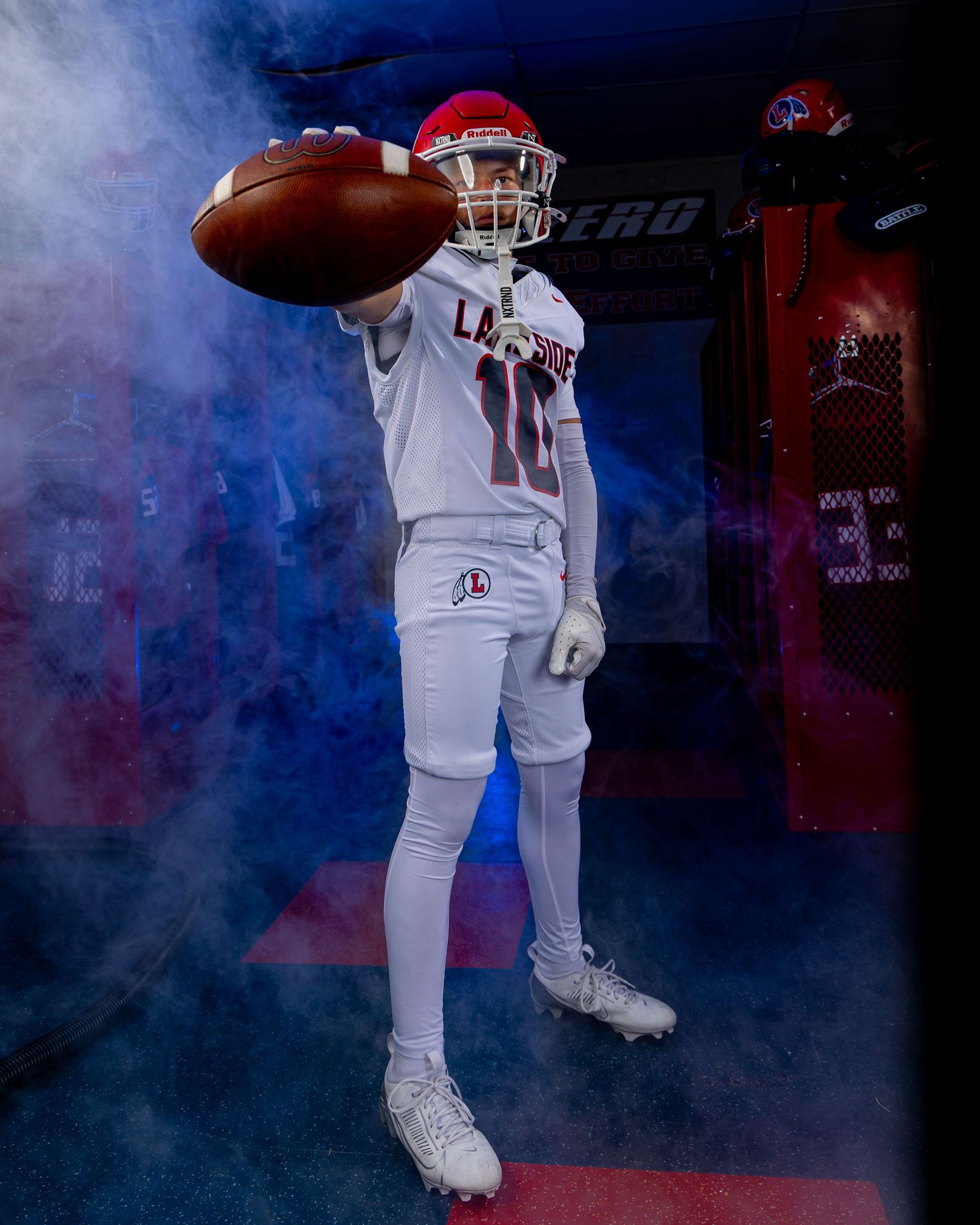 Baseball players emerge dramatically in white uniforms through misty smoke effects during team introduction.