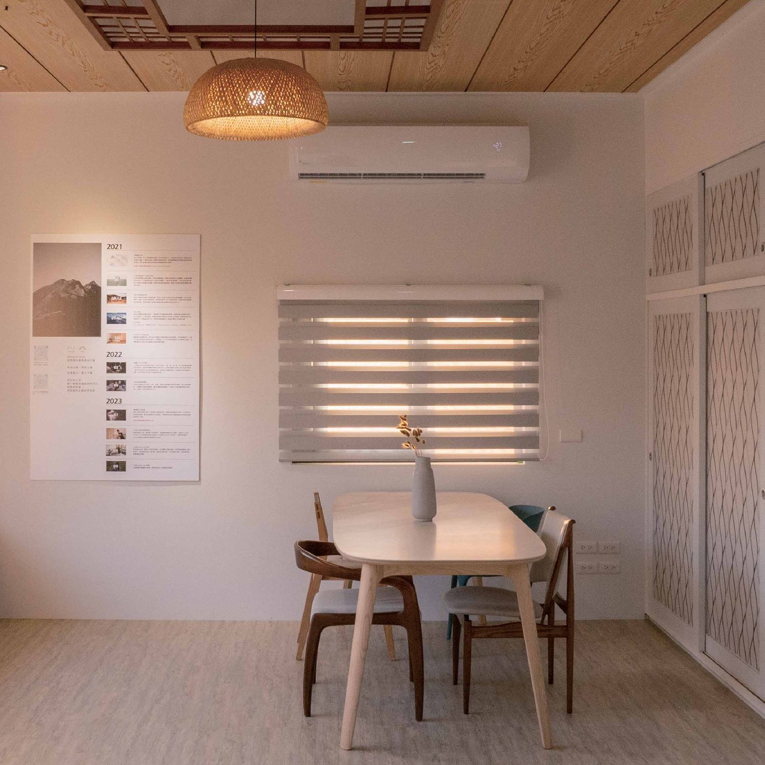 Modern meeting room interior with white walls, wooden floors, and minimalist pendant lighting fixtures.