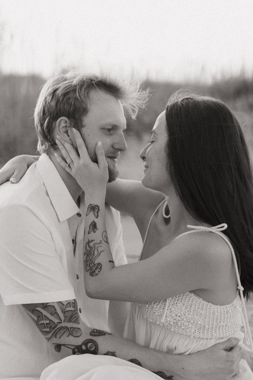 A romantic couple in black and white sharing tender moments in a sequence of intimate photographs.