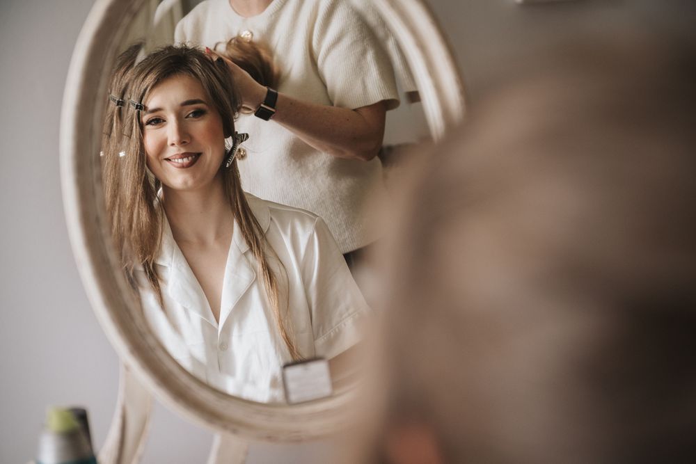 Dreamy bridal portraits captured through round mirror reflections with soft natural lighting and neutral tones.