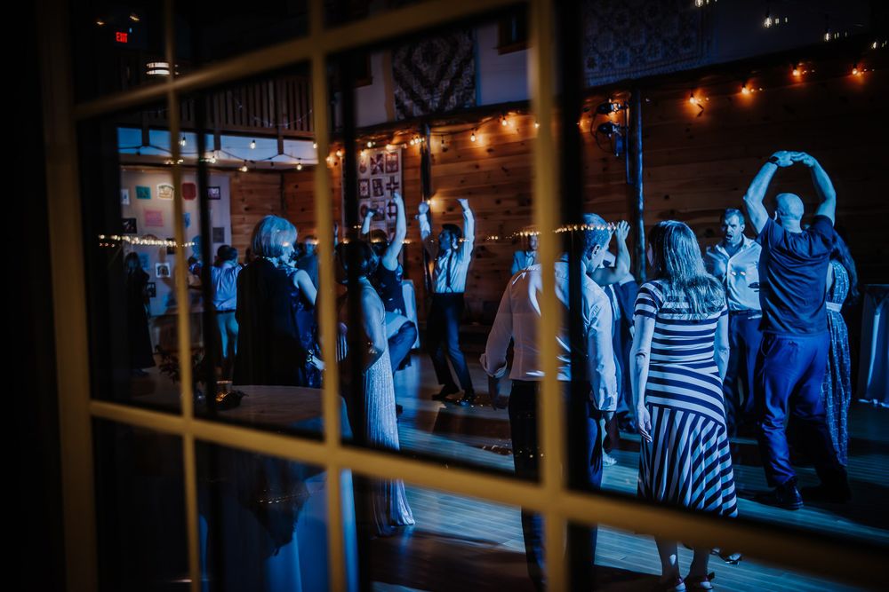Dimly lit restaurant interior with string lights creating a warm ambiance across multiple dining spaces.
