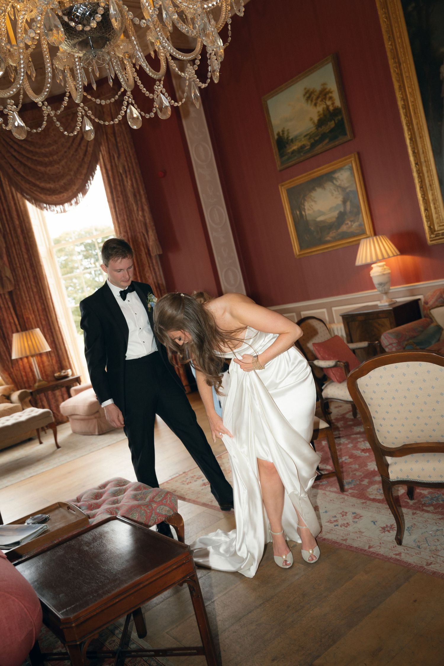A sequence of wedding photographs showing interactions between a couple in formal attire in an elegant room with chandeliers.