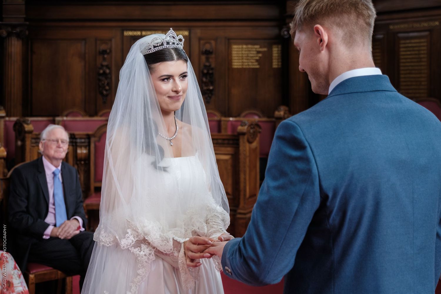 A bride and groom exchange rings during their traditional church wedding ceremony.