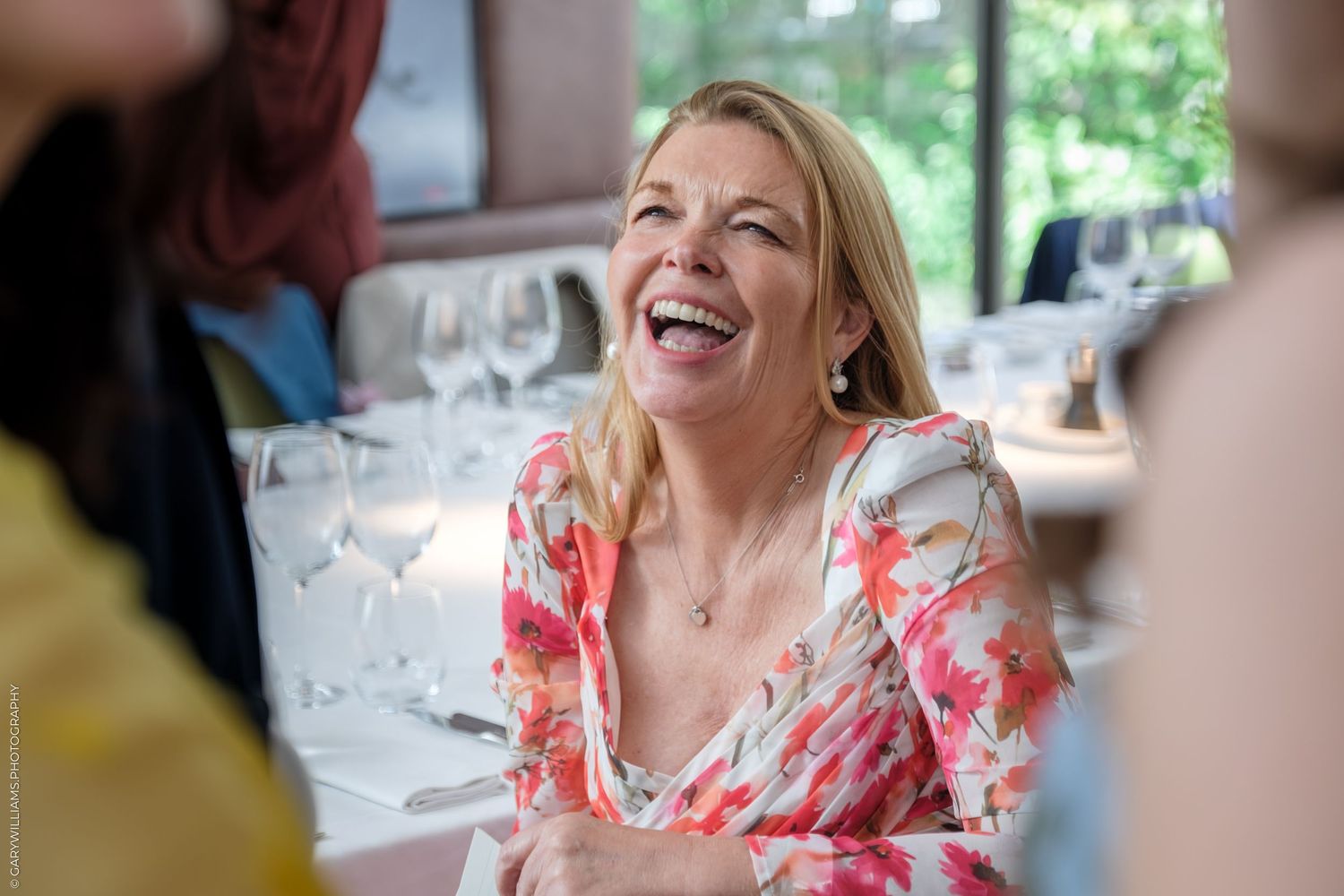 Animated candid dinner party moments showing guests enjoying laughter and conversation at an elegant table setting.