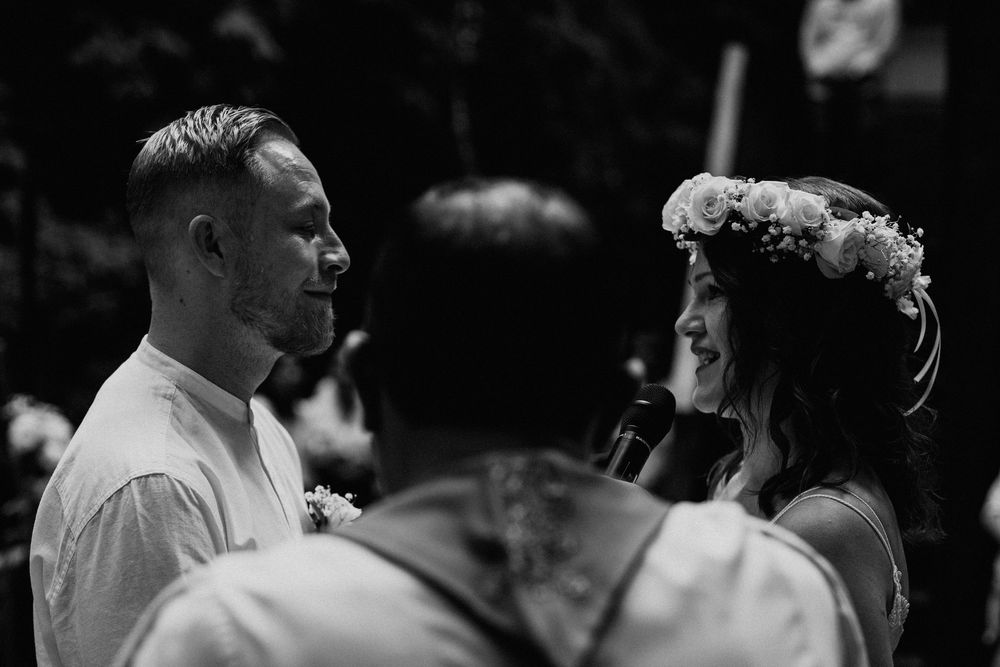 Black and white wedding portraits showing joyful moments during a garden ceremony.