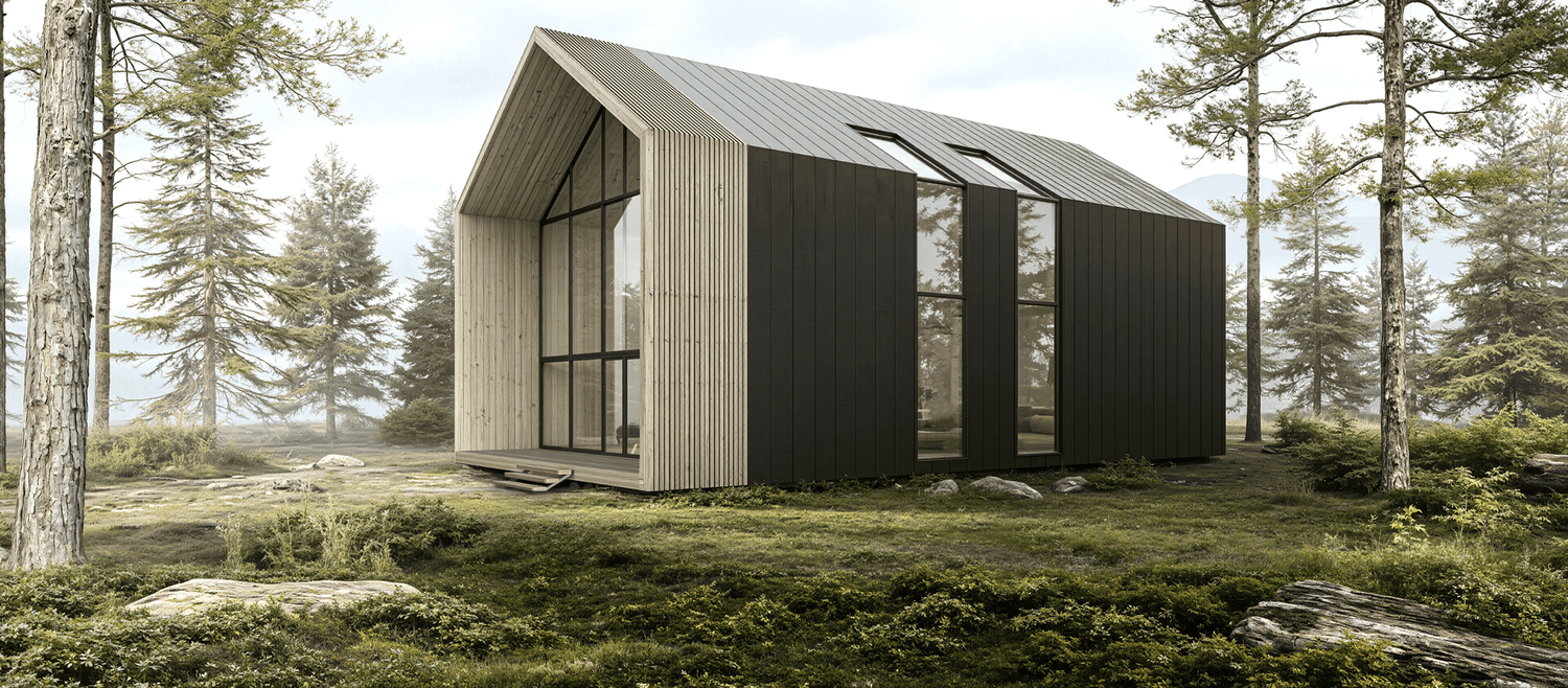 Panoramic view of a modern black cabin nestled among tall pine trees on a hillside landscape.