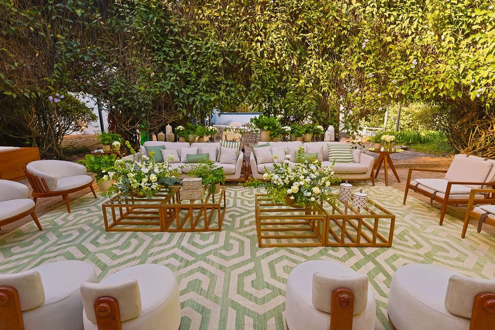 A series of outdoor wedding reception details with white seating and lush garden landscaping in natural sunlight.