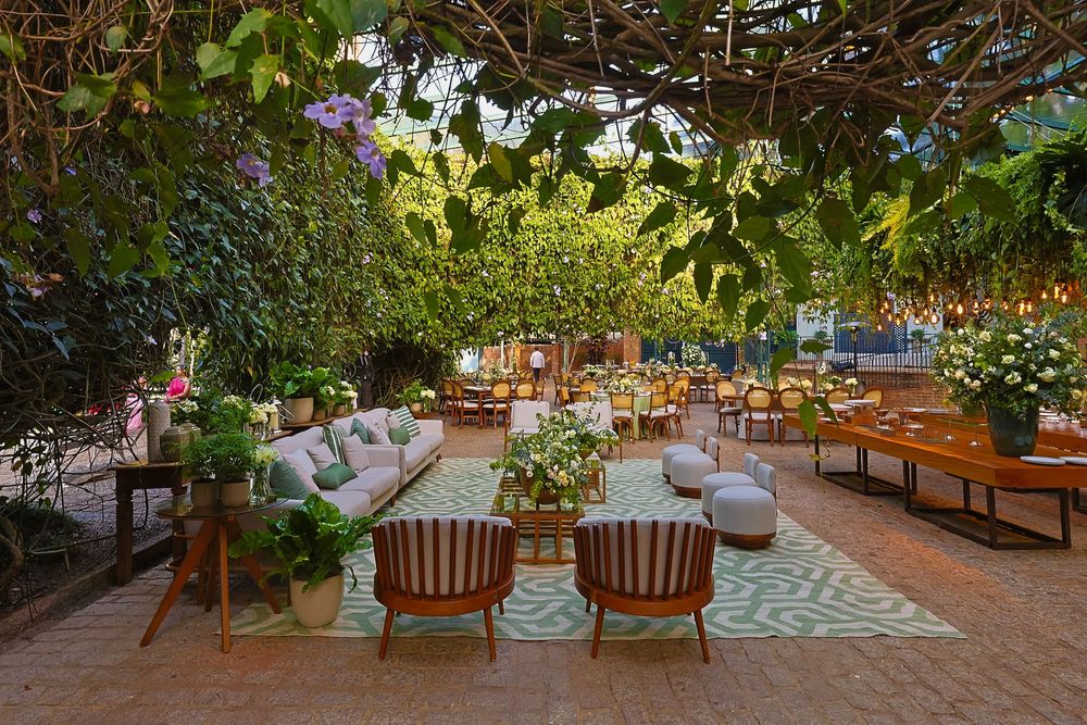 A serene outdoor patio area showcases multiple lounge chairs nestled among lush greenery and natural lighting.