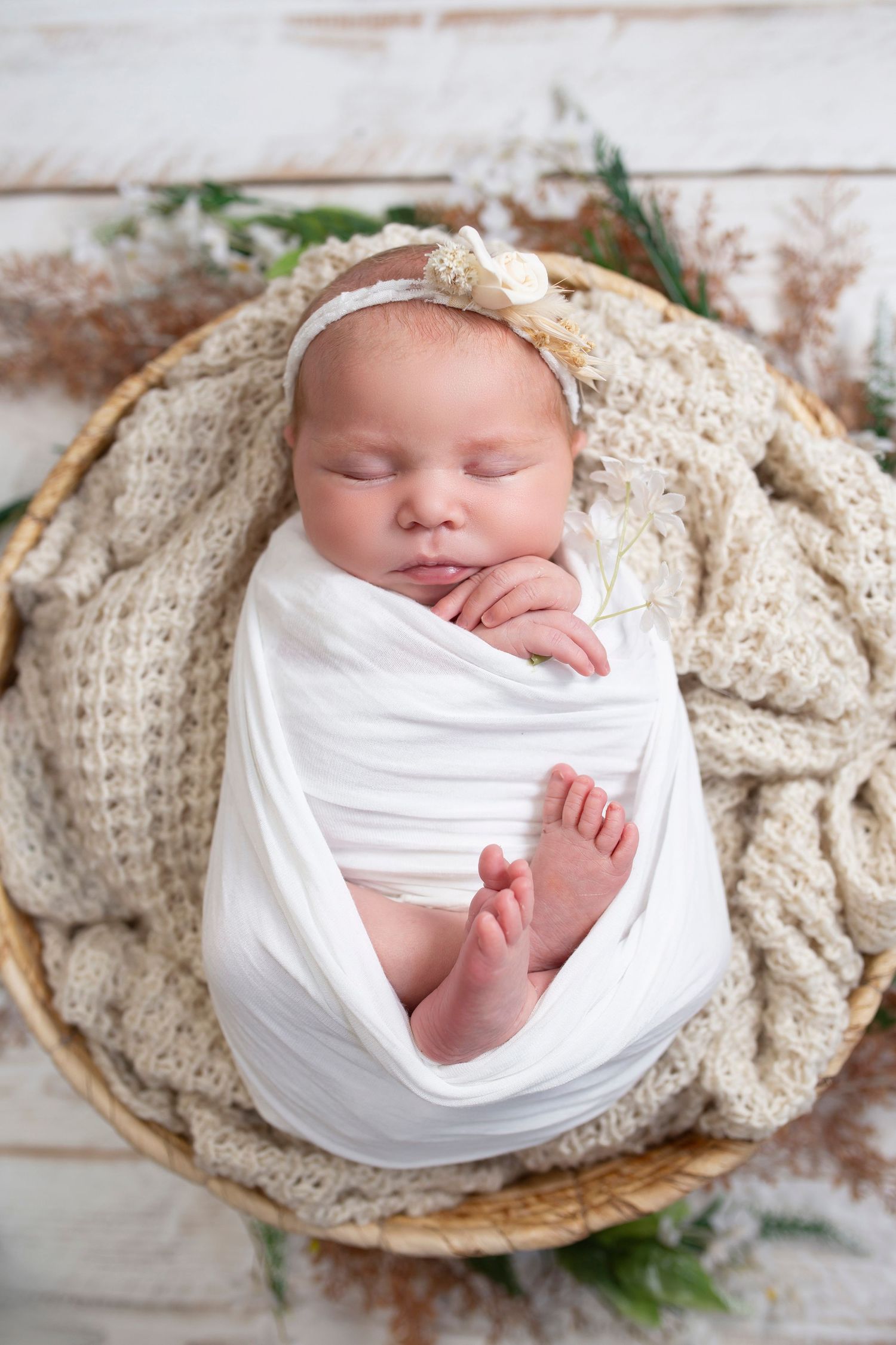 Newborn baby swaddle in basket by Little Wonderland Photography Widnes Cheshire