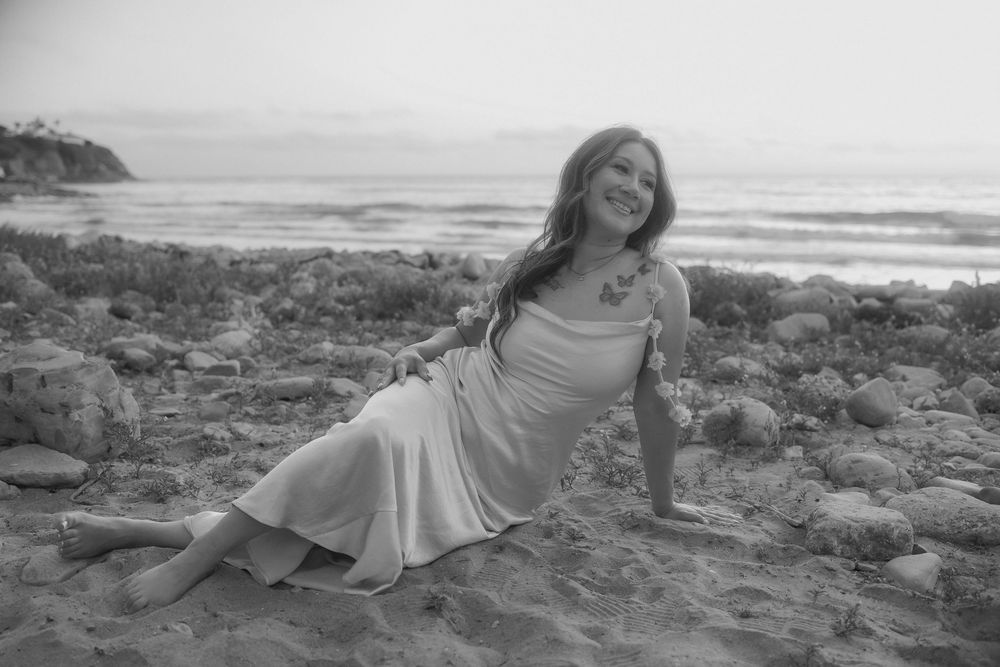 A series of black and white photos showing graceful poses on a rocky beach with crashing waves and coastal scenery.