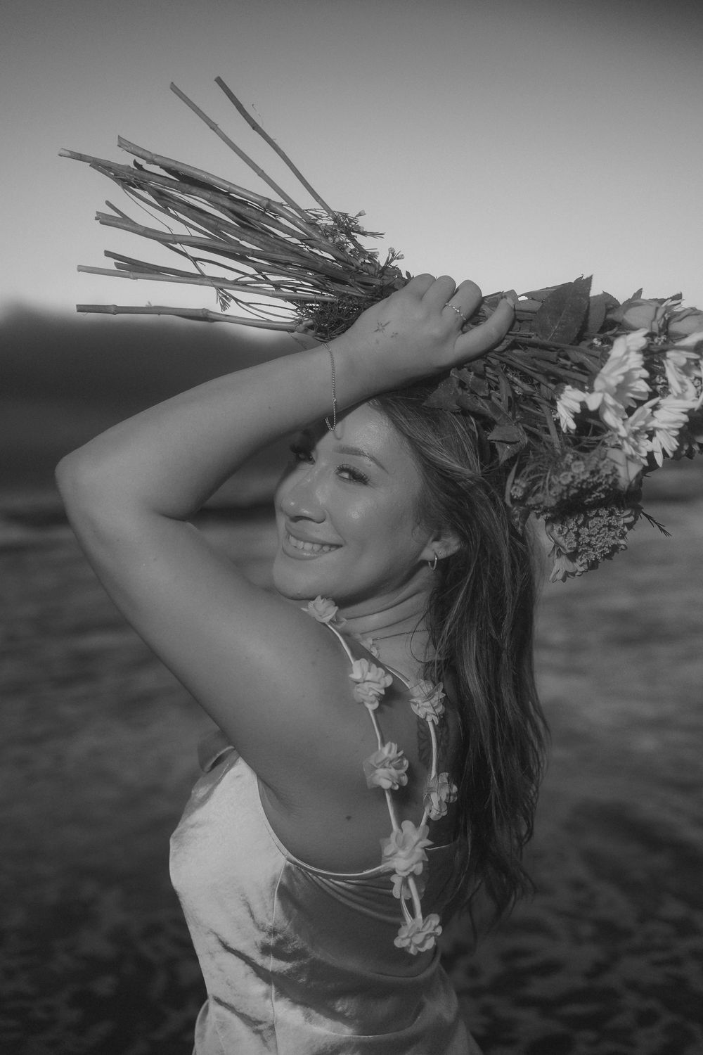 A sequence of black and white photos showing a dancer wearing a lei and feather headdress performing graceful movements.