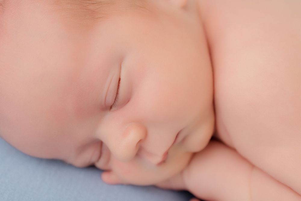 Sweet photo montage of an infant sleeping peacefully in different positions with tiny details of their face visible.