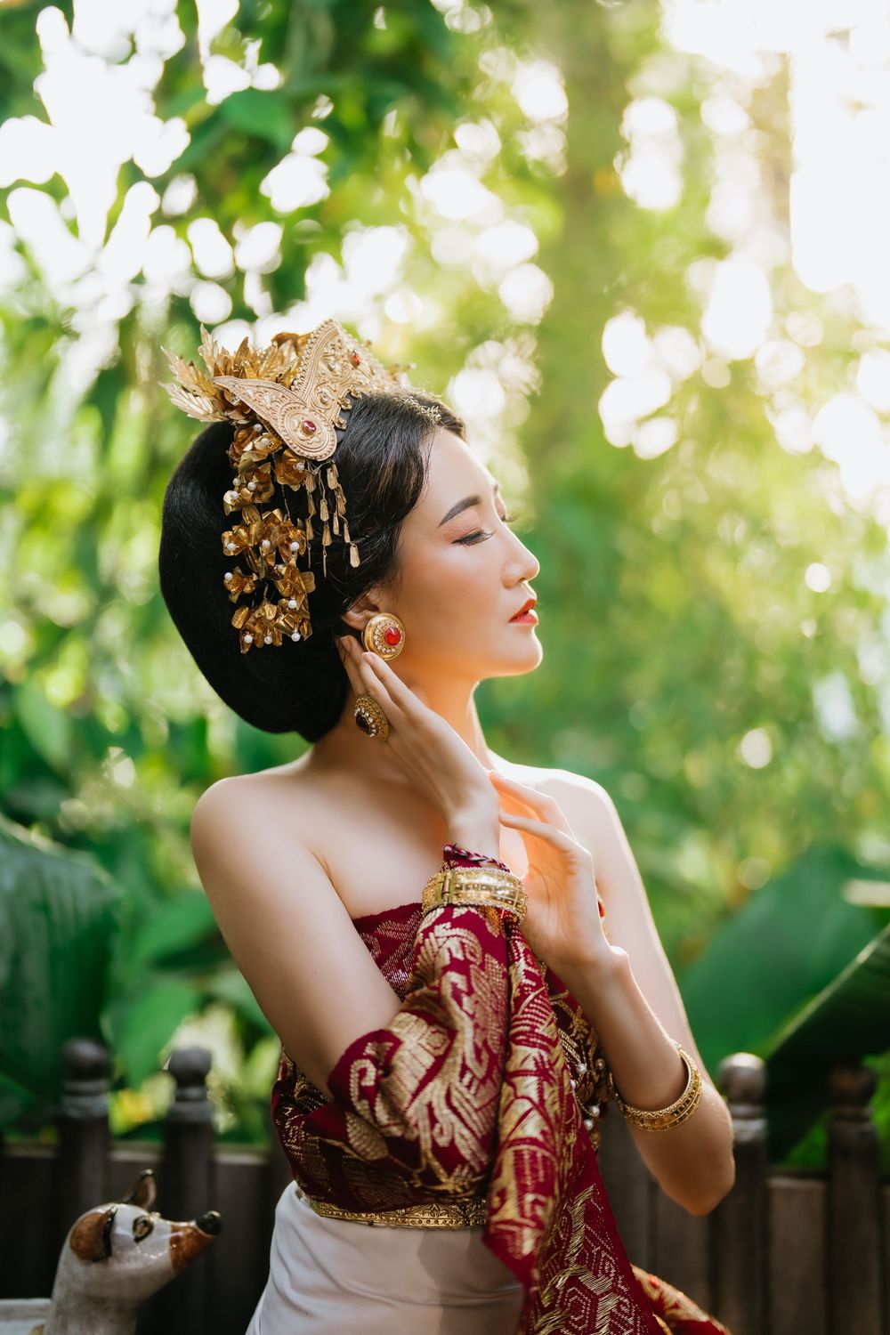 Elegant portrait in traditional Indonesian dress with gold hair accessories.
