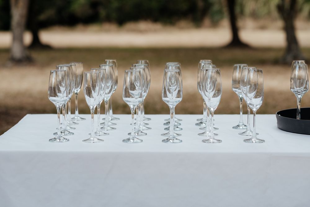 Rows of elegant champagne glasses lined up on table at Tironui Farm Martinborough by August and Vine