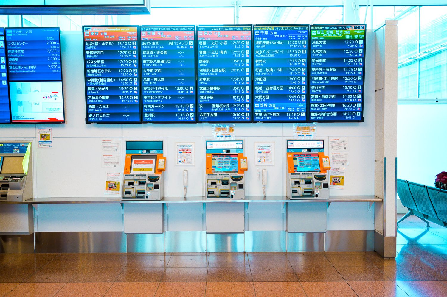 Digital LED display boards showing flight schedules and information at an airport terminal.