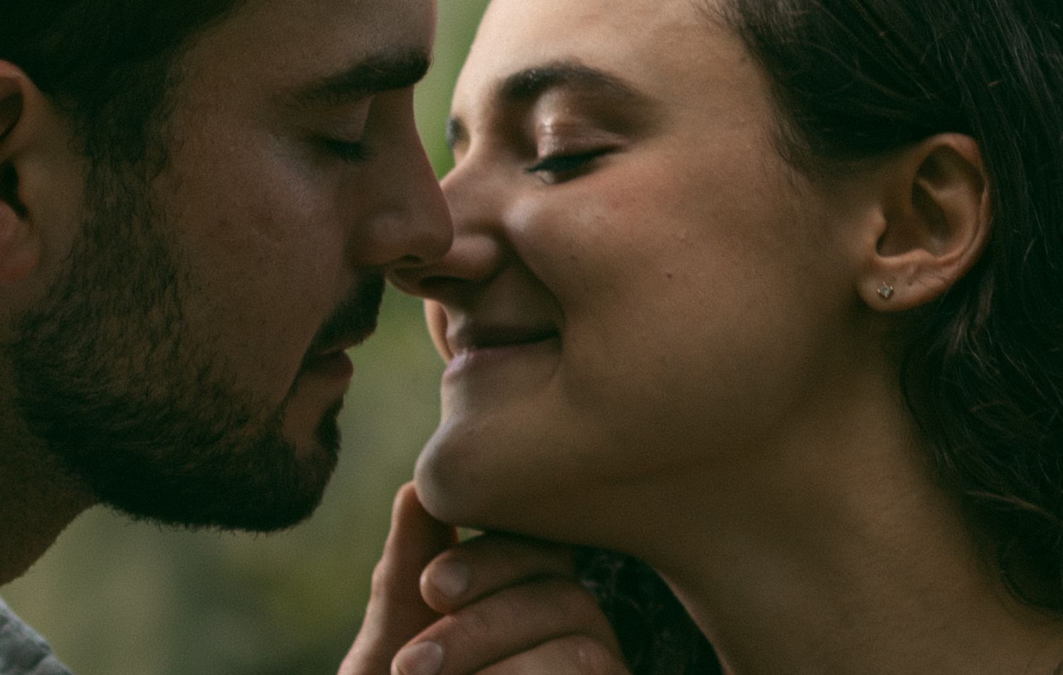 An intimate close-up portrait captured in soft natural lighting outdoors.