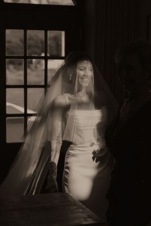 Artistic black and white bridal portraits through window light.