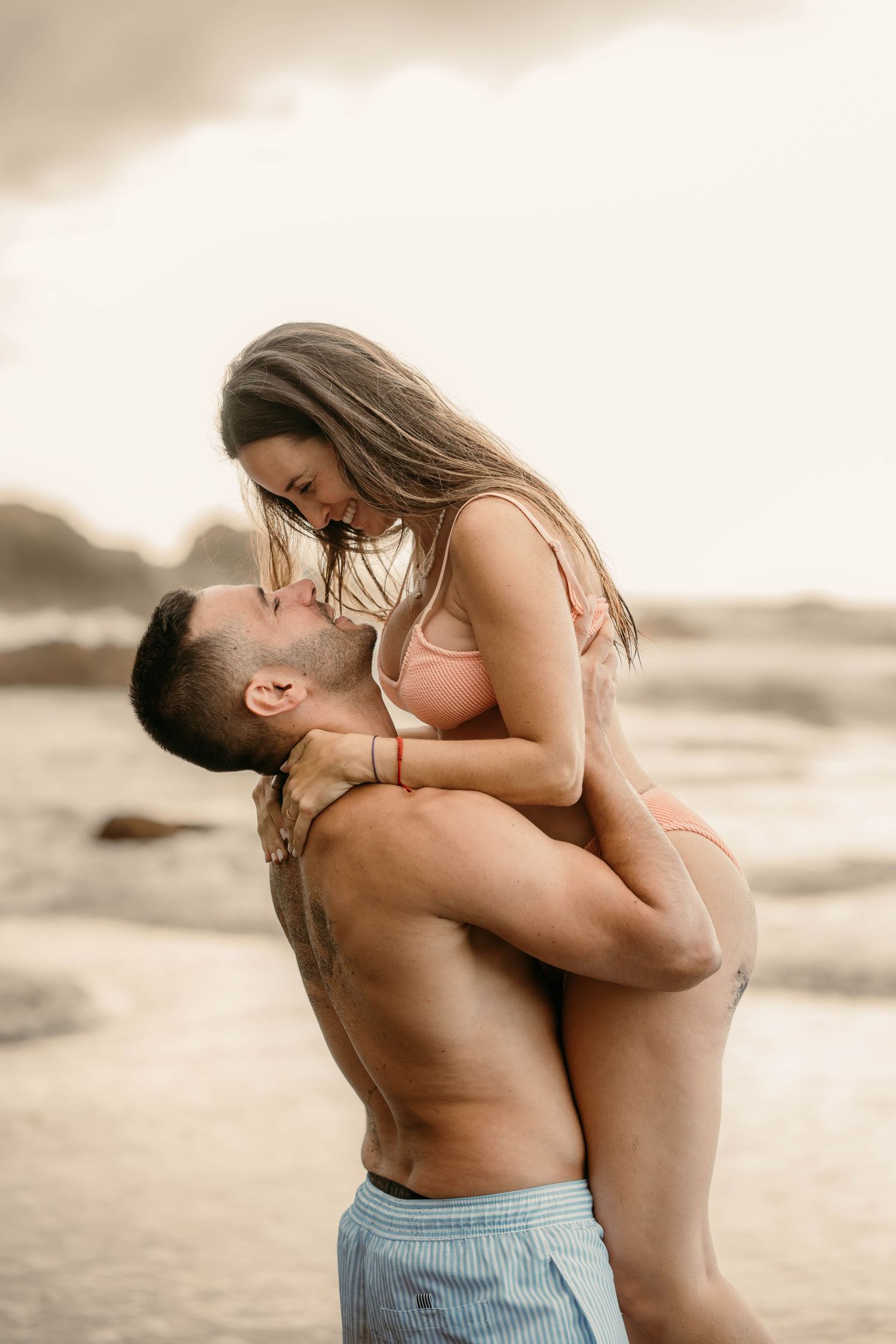 A serene maternity photoshoot at Playa Bollullo, Tenerife, Canary Islands. Celebrating the beauty of motherhood by the ocean's waves.