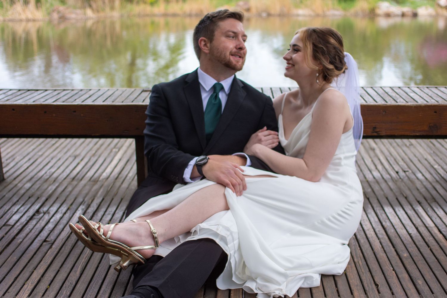 Bride and groom laugh together on wedding day in their Salt Lake City, Utah venue.