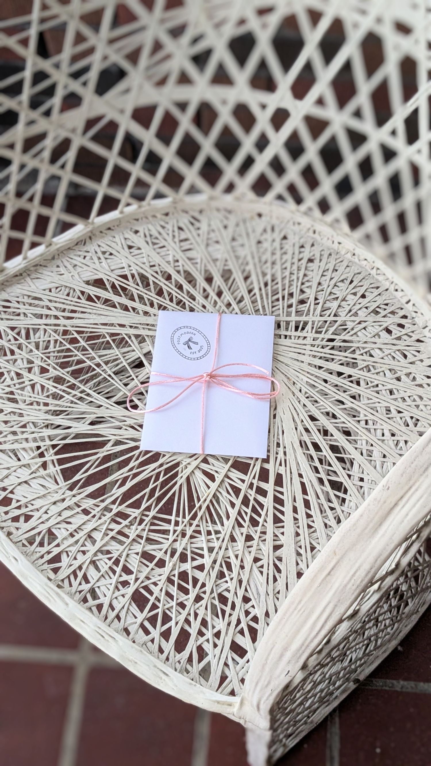 A close-up sequence of small envelopes placed on an intricate white string art heart sculpture creating a romantic display.