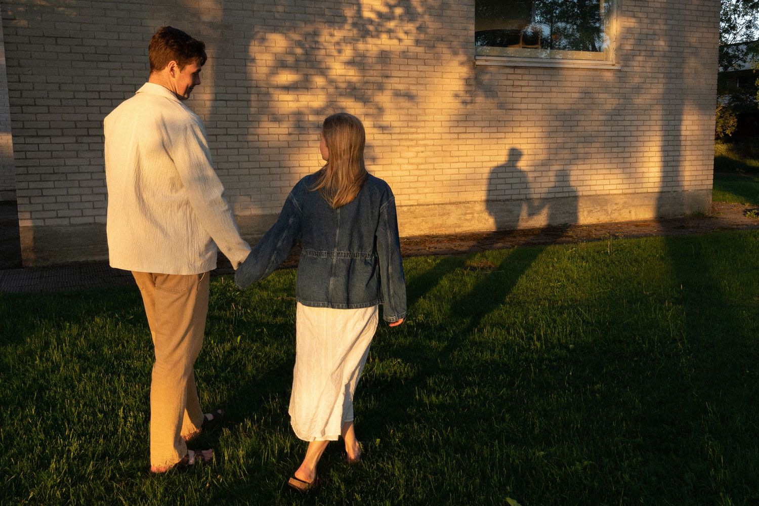 First look moment captured on brick pathway surrounded by lush garden scenery.