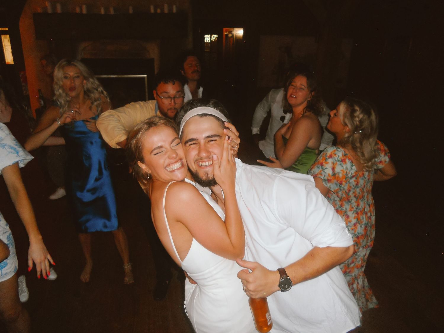 Couple dancing together at nighttime party under dim lighting. Auckland Wedding Photographer and videographer