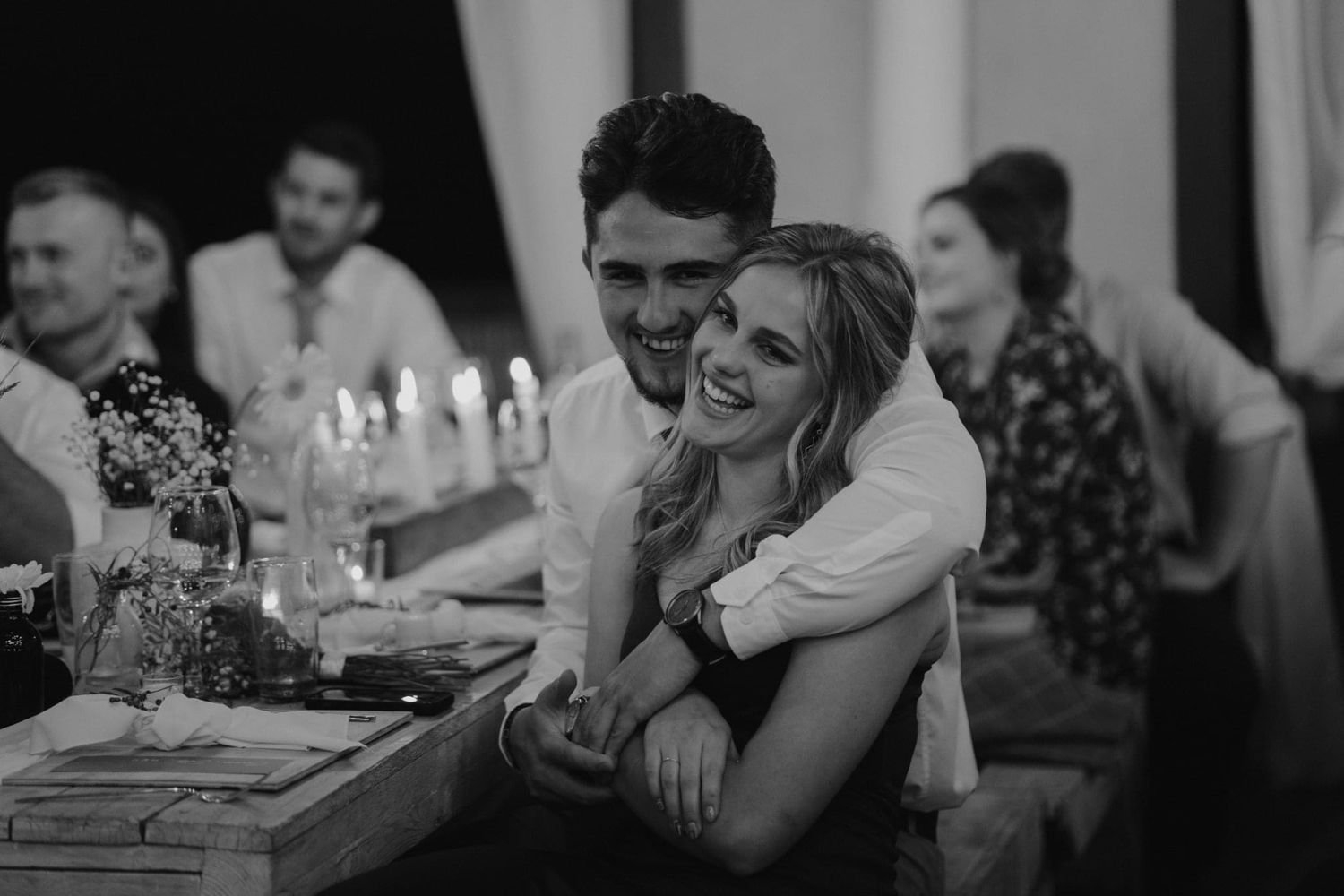 A black and white sequence of candid moments at a social gathering.