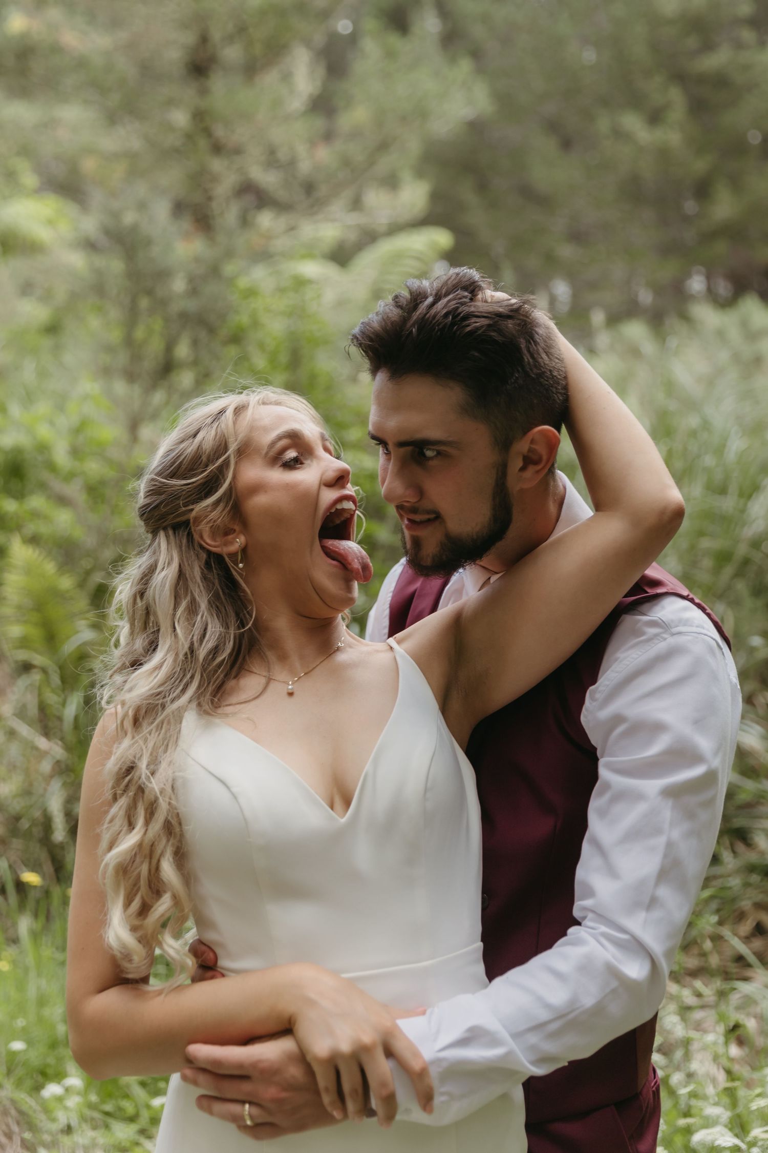 A romantic photoshoot in a natural setting with white and burgundy attire. Auckland Wedding Photographer and videographer