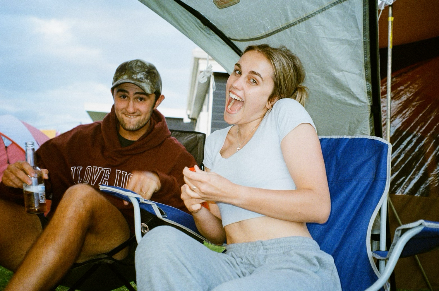 People enjoying themselves at a casual outdoor event with tents.