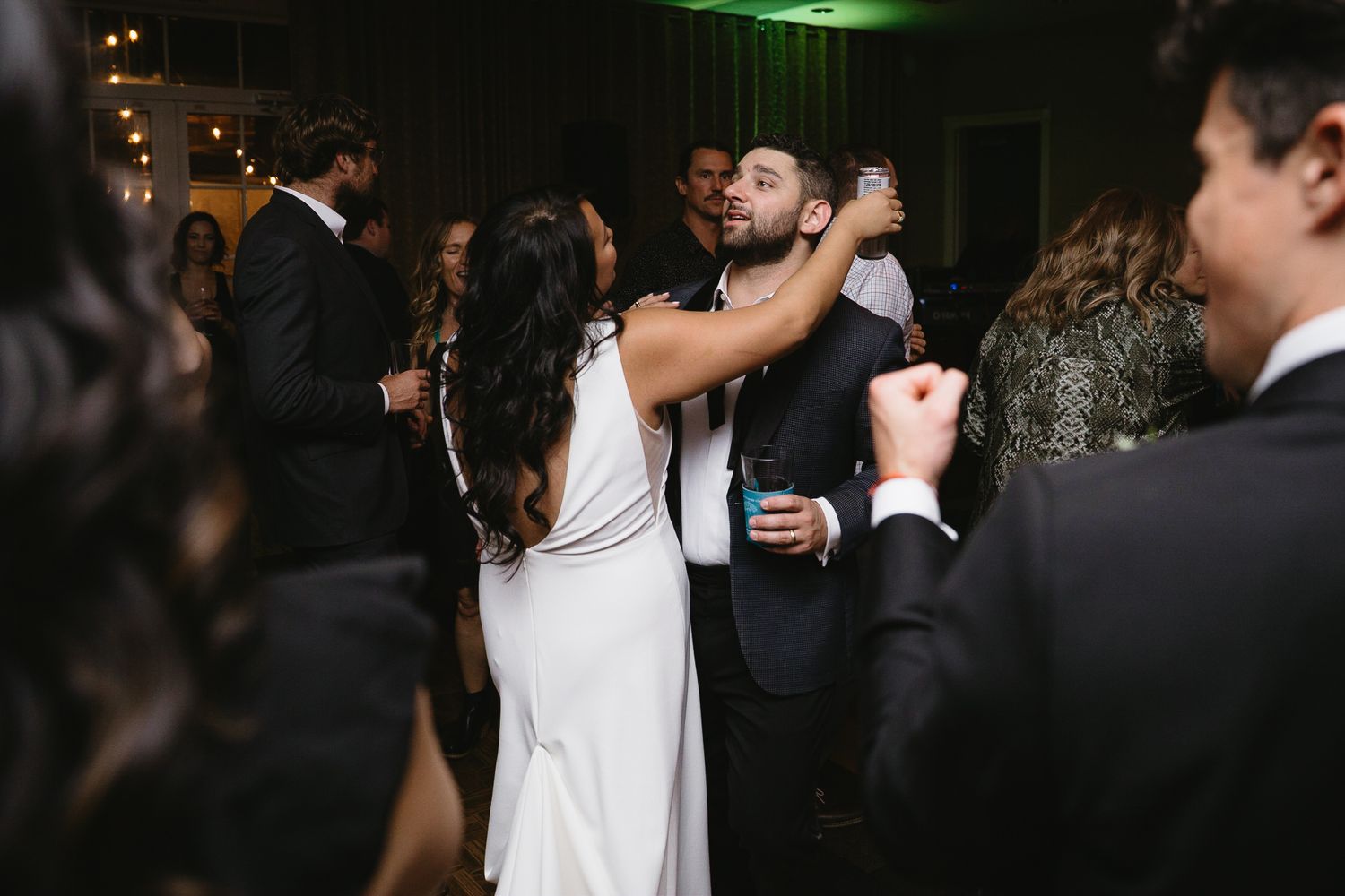 A black and white photo collage shows people laughing and having fun at what appears to be a social gathering.